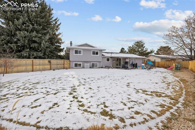 view of snow covered rear of property