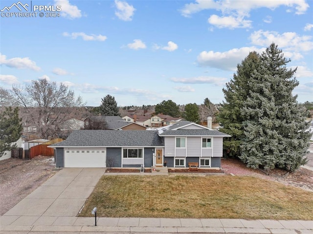 view of front of home with a front lawn and a garage