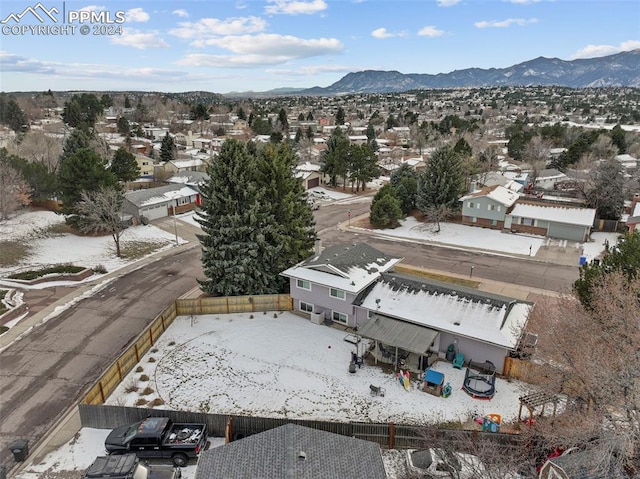 snowy aerial view featuring a mountain view