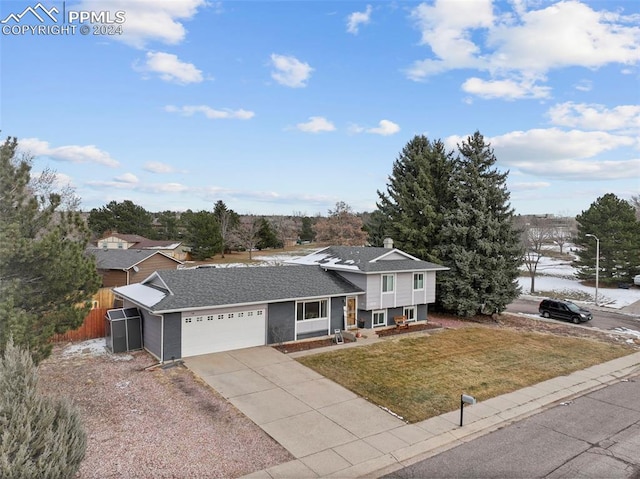 view of front of property with a garage and a front lawn