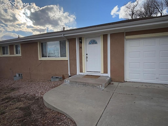 doorway to property featuring a garage