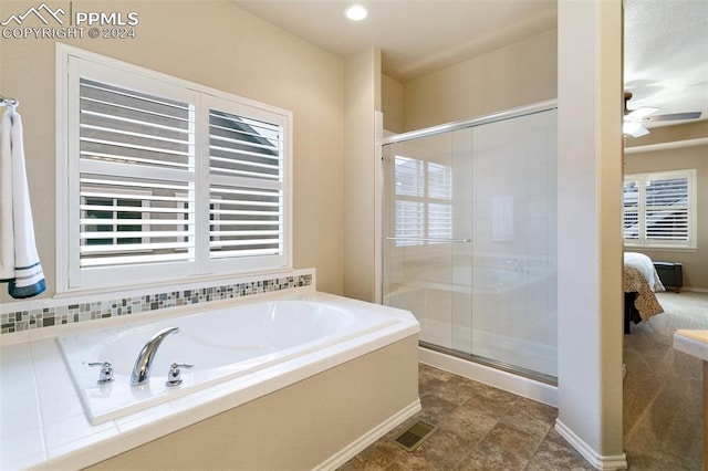 bathroom featuring ceiling fan and plus walk in shower