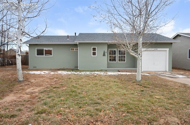 view of front of property with a front lawn and a garage