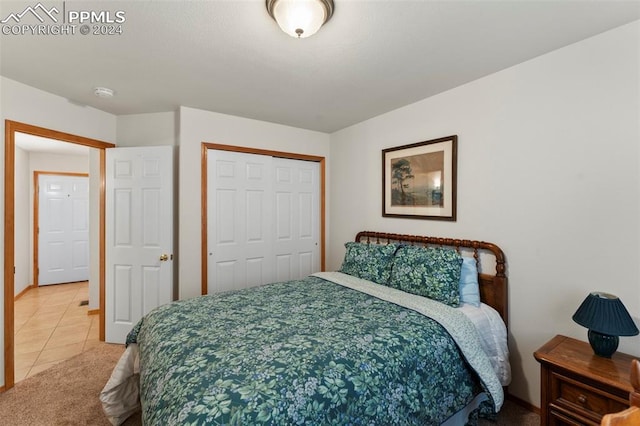 bedroom featuring tile patterned flooring and a closet