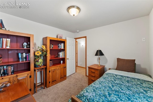 bedroom featuring light carpet