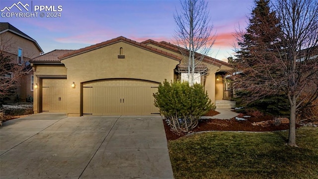 mediterranean / spanish house with a garage