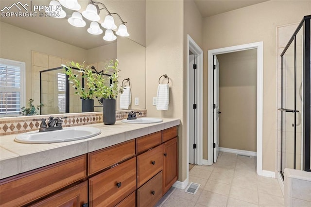 bathroom with tile patterned floors, vanity, and walk in shower