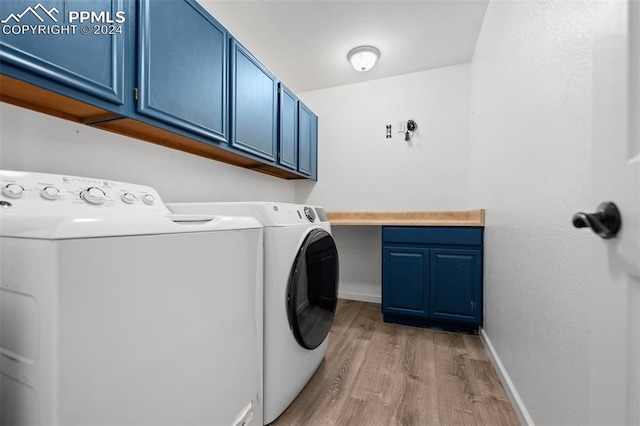 clothes washing area featuring cabinets, light hardwood / wood-style floors, and separate washer and dryer