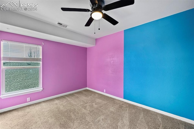 spare room featuring carpet floors and ceiling fan