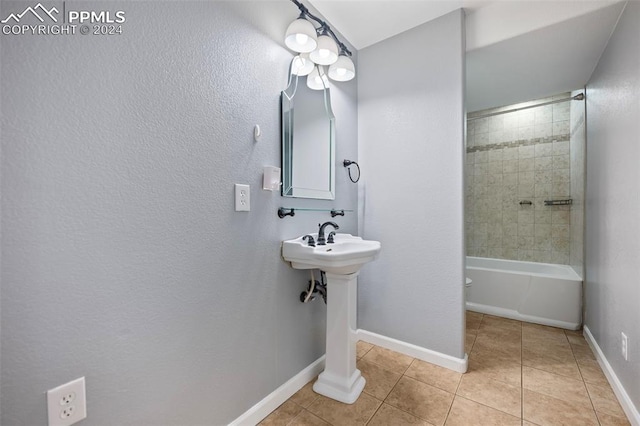 bathroom with tiled shower / bath combo and tile patterned floors