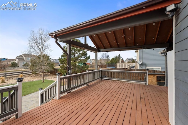 wooden terrace featuring a patio area and a yard