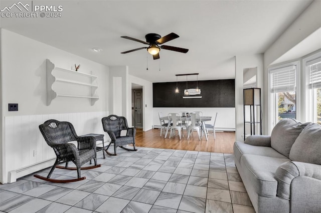 living room with ceiling fan and light hardwood / wood-style floors