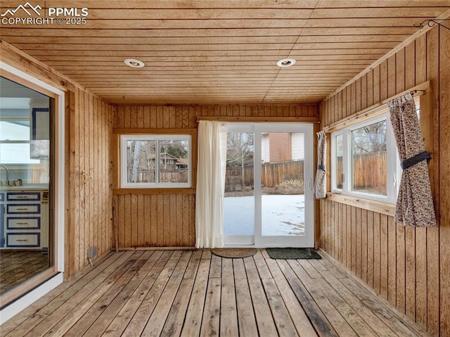 unfurnished sunroom featuring wooden ceiling