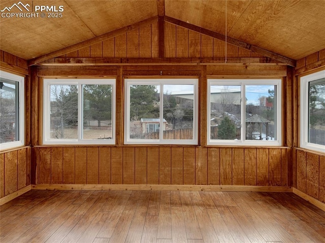 unfurnished sunroom featuring vaulted ceiling