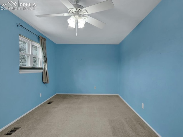 carpeted spare room with ceiling fan