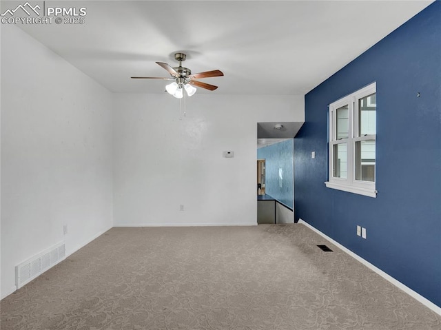 empty room featuring ceiling fan and carpet floors