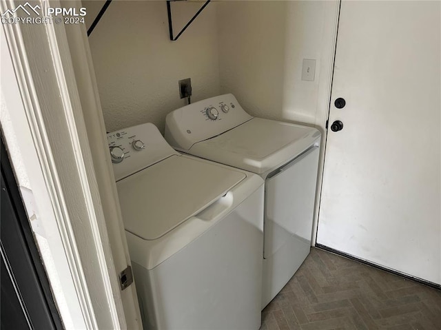 washroom featuring separate washer and dryer and parquet floors