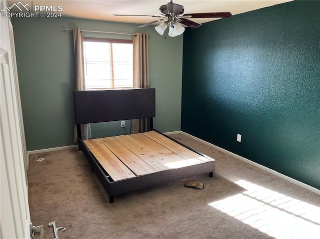 unfurnished bedroom featuring carpet and ceiling fan