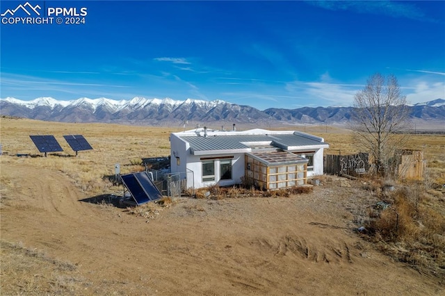 exterior space featuring a mountain view, a rural view, and solar panels