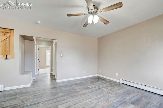 unfurnished room with ceiling fan, wood-type flooring, and baseboard heating