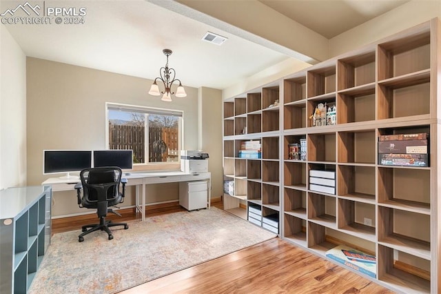 office space featuring a chandelier and wood-type flooring