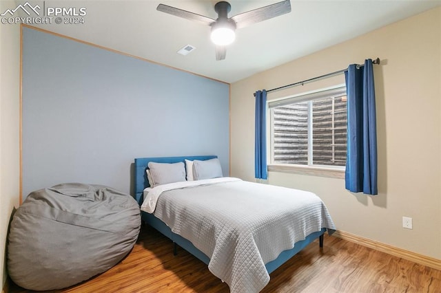 bedroom with hardwood / wood-style floors and ceiling fan