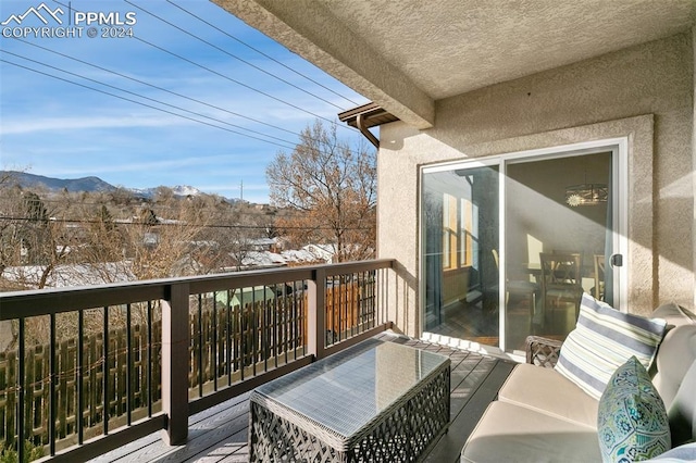 snow covered back of property featuring a mountain view