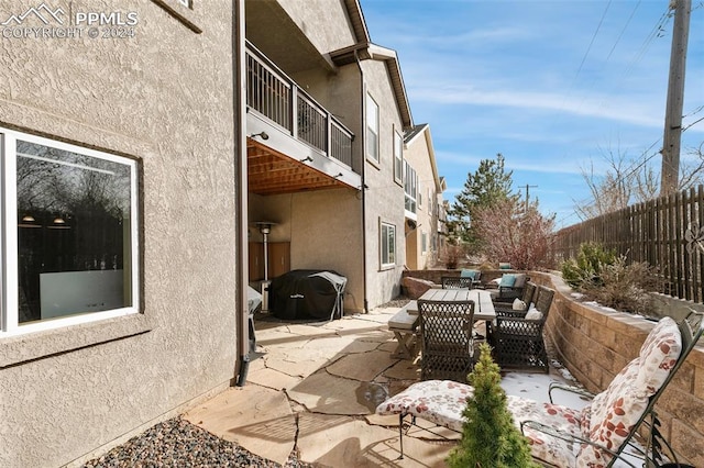 view of patio / terrace featuring a grill and a balcony