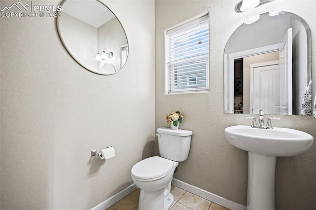 bathroom with tile patterned floors, sink, and toilet