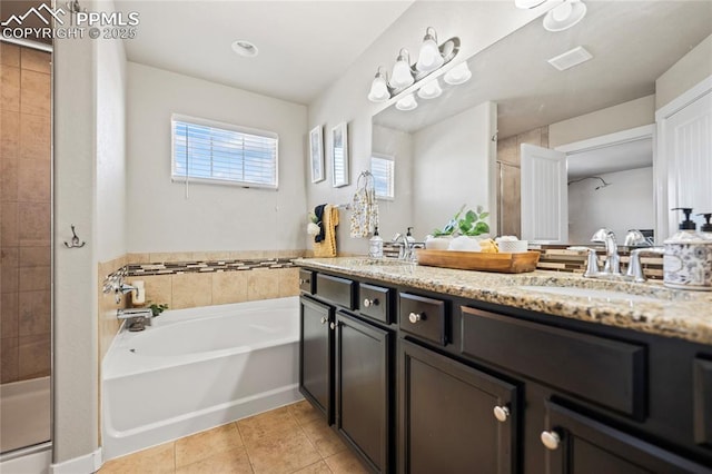 bathroom with tile patterned flooring, vanity, and plus walk in shower