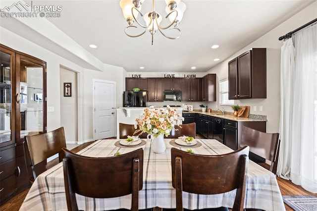 dining space with a chandelier and hardwood / wood-style flooring