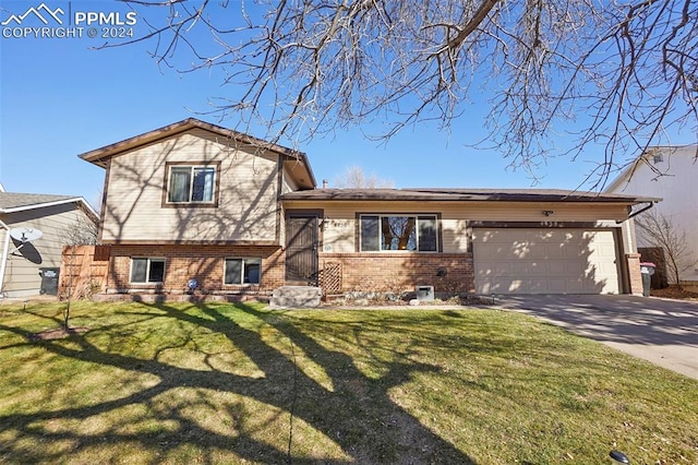 split level home with a front lawn and a garage