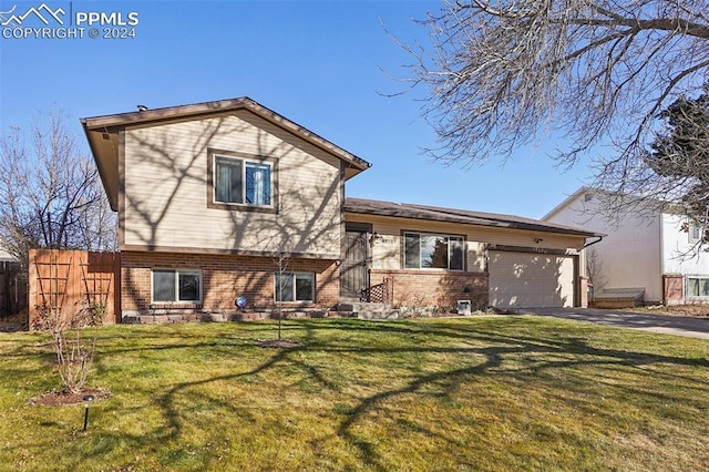 view of front of home with a front lawn and a garage