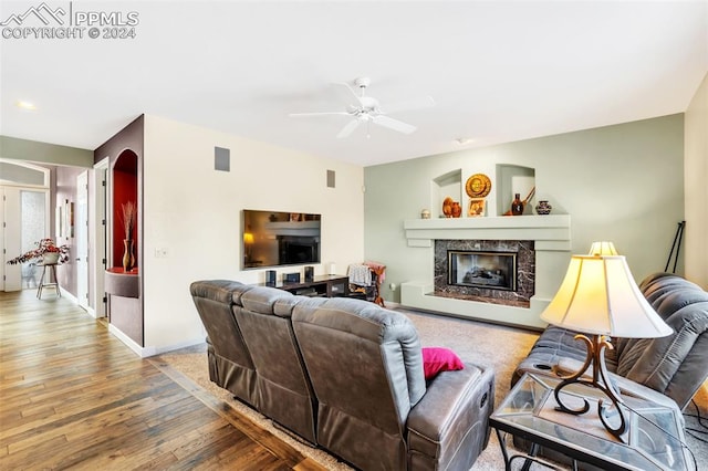 living room with a fireplace, hardwood / wood-style flooring, and ceiling fan