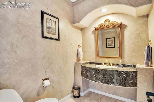 bathroom with tile patterned flooring, toilet, and sink