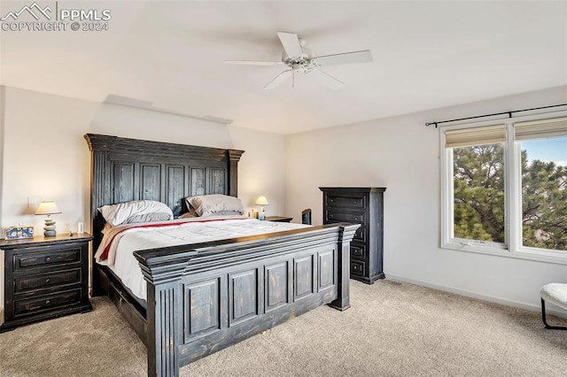 bedroom featuring light colored carpet and ceiling fan