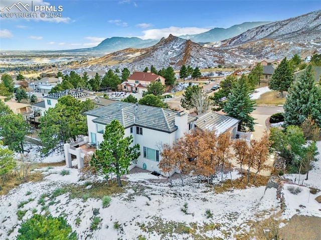 snowy aerial view featuring a mountain view