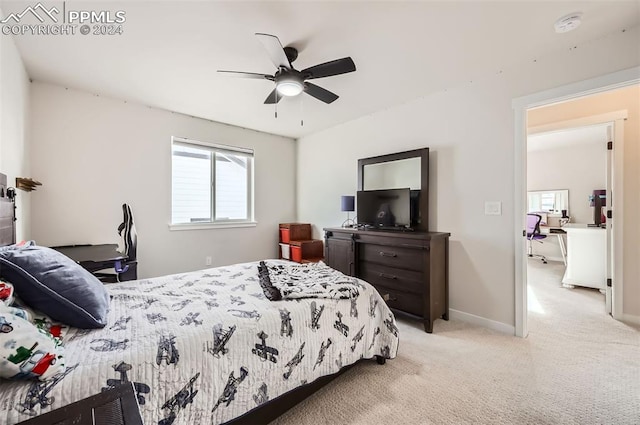 bedroom with ceiling fan and light carpet