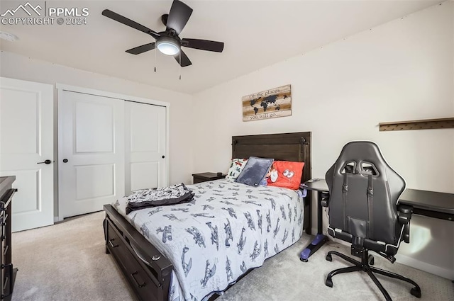 carpeted bedroom with ceiling fan and a closet