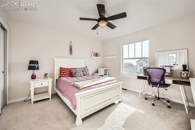 bedroom featuring light colored carpet and ceiling fan