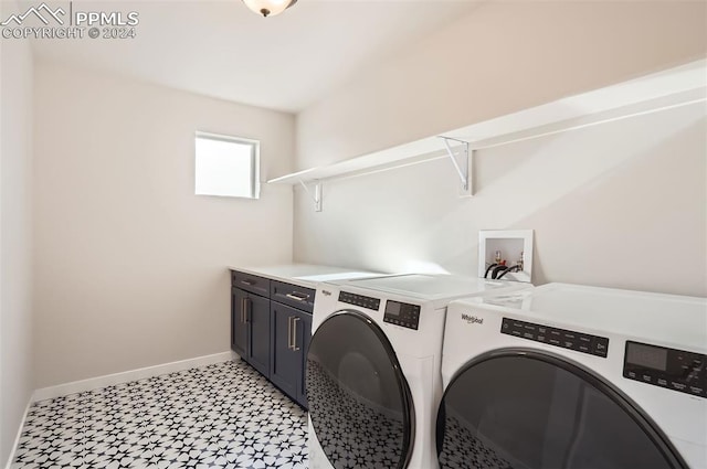 laundry room with cabinets and washer and clothes dryer