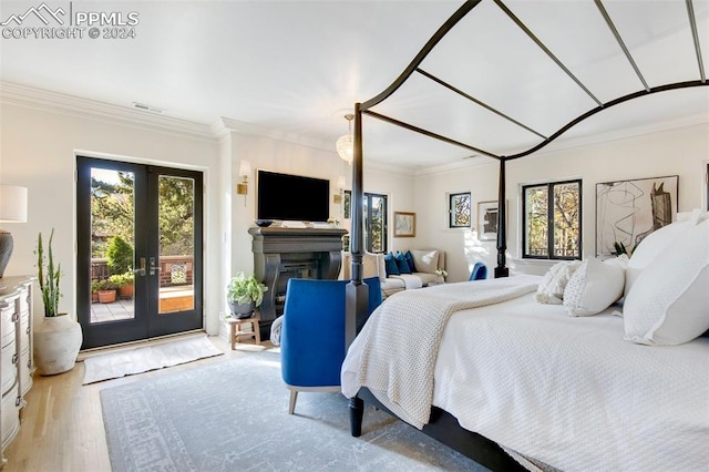 bedroom featuring french doors, light wood-type flooring, access to outside, and crown molding