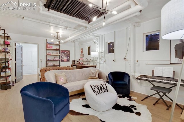 living room featuring light hardwood / wood-style floors and a notable chandelier