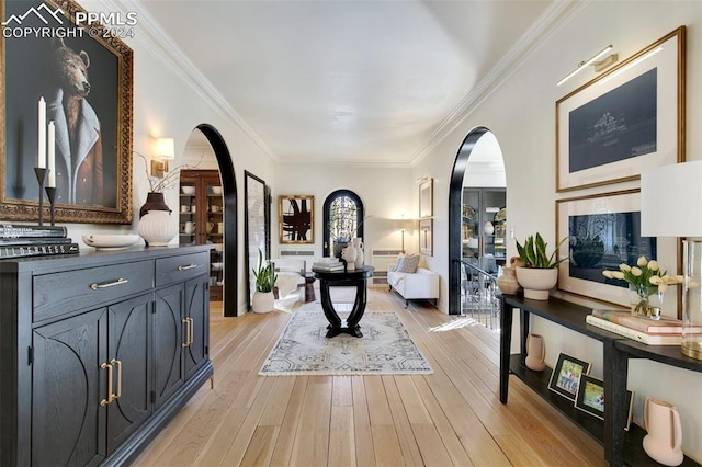 entryway with light hardwood / wood-style flooring and ornamental molding