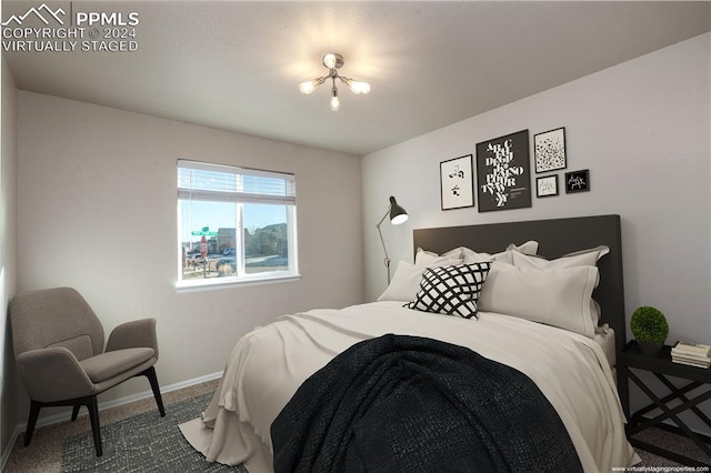 bedroom with carpet flooring and an inviting chandelier