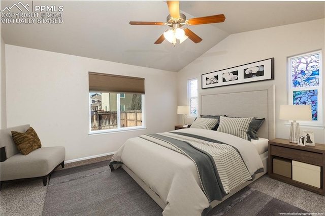 bedroom featuring dark colored carpet, ceiling fan, and lofted ceiling