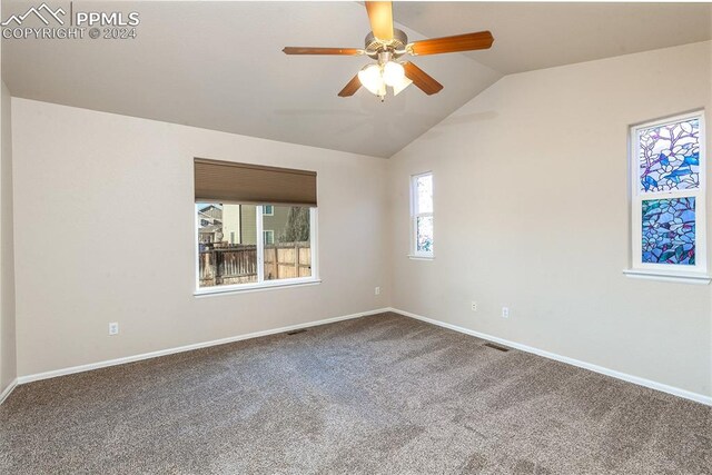 unfurnished room featuring carpet, ceiling fan, and lofted ceiling