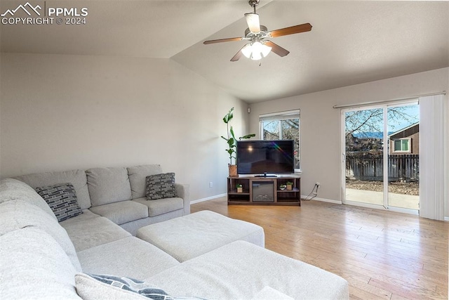 living room with ceiling fan, wood-type flooring, and lofted ceiling