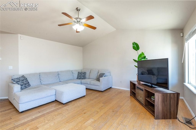 living room with ceiling fan, vaulted ceiling, a wealth of natural light, and light hardwood / wood-style flooring