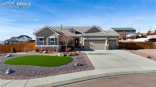 view of front of property with a garage and a front lawn